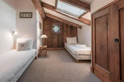 a bedroom with two beds and a window at La Poya haut - Calme - Vues magnifiques in Les Houches