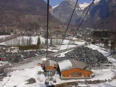 a group of people riding a ski lift in the snow at SAMOENS appartement proche du centre in Samoëns