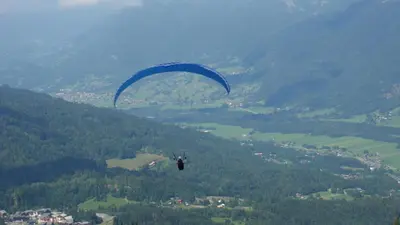 a person flying a parachute in the air at SAMOENS appartement proche du centre in Samoëns
