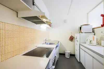 a small kitchen with a sink and a refrigerator at Résidence Aldébaran - maeva Home - Appartement 2 Pièces 6 Personnes - Confort MAE-3790 in Arâches-la-Frasse