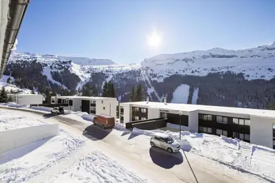 a ski lodge with a car parked in the snow at Résidence Gémeaux - maeva Home - Appartement 2 Pièces 6 Personnes - Confort MAE-3874 in Arâches-la-Frasse