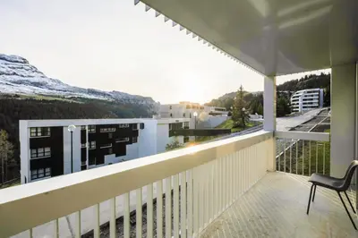 a balcony with a chair and a view at Résidence La Petite Ourse - maeva Home - Appartement 3 Pièces 8 Personnes - Confort MAE-3901 in Arâches-la-Frasse