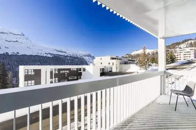 a chair on a balcony with a view of the mountains at Résidence La Petite Ourse - maeva Home - Appartement 3 Pièces 8 Personnes - Confort MAE-3901 in Arâches-la-Frasse