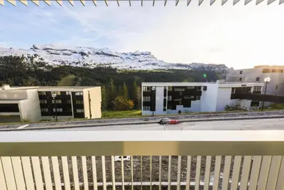 a view from the balcony of a building with snow covered mountains at Résidence La Petite Ourse - maeva Home - Appartement 3 Pièces 8 Personnes - Confort MAE-3901 in Arâches-la-Frasse