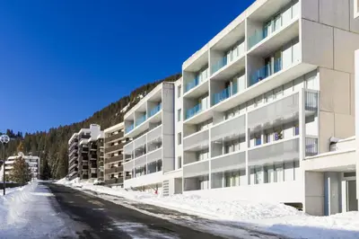 an empty street in front of a building in the snow at Résidence La Petite Ourse - maeva Home - Appartement 3 Pièces 8 Personnes - Confort MAE-3901 in Arâches-la-Frasse