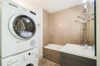 a washing machine in a bathroom with a sink at Résidence La Petite Ourse - maeva Home - Appartement 3 Pièces 8 Personnes - Confort MAE-3901 in Arâches-la-Frasse