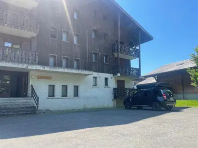 a car parked in front of a building at Studio rénové proche centre Samoëns avec balcon et proximité ski-bus - FR-1-624-159 in Samoëns