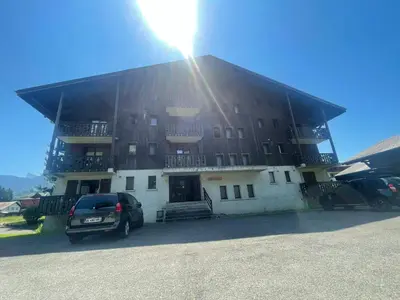 a building with a car parked in front of it at Studio rénové proche centre Samoëns avec balcon et proximité ski-bus - FR-1-624-159 in Samoëns
