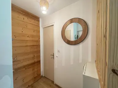 a bathroom with a mirror and a wooden wall at Studio rénové proche centre Samoëns avec balcon et proximité ski-bus - FR-1-624-159 in Samoëns