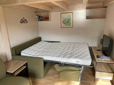a small room with a bed and a tv at Studio cocooning à Samoëns avec balcon et WiFi au centre - FR-1-624-160 in Samoëns