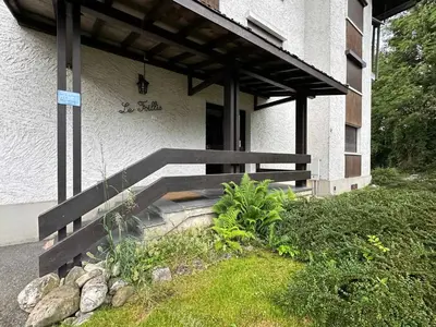 a building with a wooden bench in front of it at Studio cocooning à Samoëns avec balcon et WiFi au centre - FR-1-624-160 in Samoëns