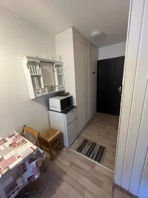 a room with a kitchen with a microwave and a table at Aiguille 2 in Chamonix-Mont-Blanc