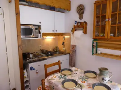 a kitchen with a table with plates on it at Résidence Pierres Blanches - Pierres Blanches F392 MAE-9901 in Les Contamines-Montjoie