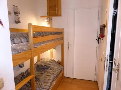 a room with two bunk beds and a door at Résidence Pierres Blanches - Pierres Blanches F392 MAE-9901 in Les Contamines-Montjoie