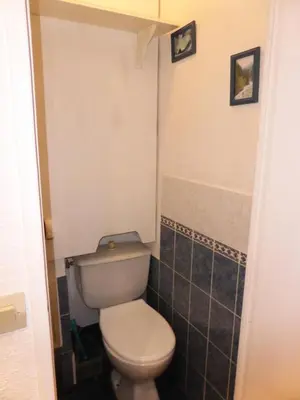 a bathroom with a white toilet and black tiles at Résidence Pierres Blanches - Pierres Blanches F392 MAE-9901 in Les Contamines-Montjoie