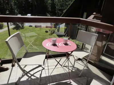 a pink table and two chairs on a balcony at Résidence Pierres Blanches - Pierres Blanches F392 MAE-9901 in Les Contamines-Montjoie