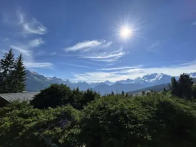 a view of the mountains with the sun in the sky at Appartement 3 Pièces + Mezzanine, 7 couchages, vue Mont-Blanc, Parking - FR-1-597-177 in Combloux