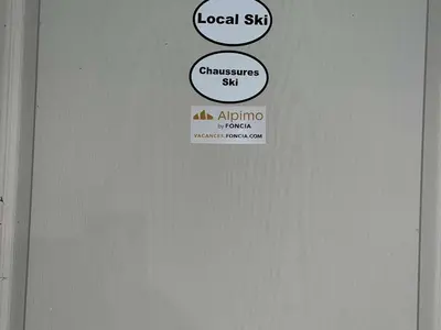 a door with a sign that says local shop andchemisesiatessama at Appartement 3 Pièces + Mezzanine, 7 couchages, vue Mont-Blanc, Parking - FR-1-597-177 in Combloux