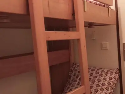a bunk bed with a ladder in a room at Studio cabine pour 4 pers, animaux acceptés, internet, vue montagne - FR-1-629-136 in Samoëns