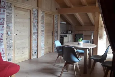 a kitchen with a table and chairs in a room at Appartement sur les pistes de Megève in Megève