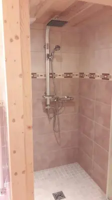 a shower with a shower head in a bathroom at Appartement sur les pistes de Megève in Megève