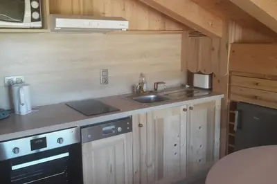 a kitchen with a sink and a stove at Appartement sur les pistes de Megève in Megève