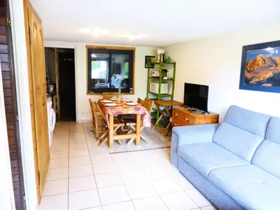 a living room with a blue couch and a table at Résidence L'air Du Temps - L'Air du Temps 10 MAE-1321 in Les Contamines-Montjoie