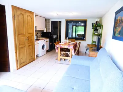 a living room with a table and a kitchen at Résidence L'air Du Temps - L'Air du Temps 10 MAE-1321 in Les Contamines-Montjoie