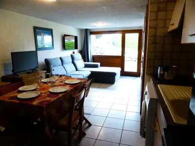 a living room with a table and a couch at Résidence L'air Du Temps - L'Air du Temps 10 MAE-1321 in Les Contamines-Montjoie
