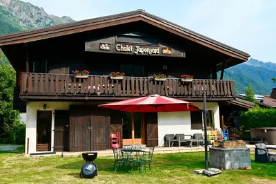 a building with a balcony with a table and an umbrella at Ideal For all type of families 
