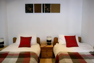 two beds sitting next to each other in a room at Ideal For all type of families 