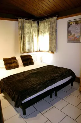 a bedroom with a large bed with a window at Ideal For all type of families 
