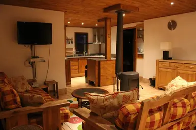 a living room with a couch and a stove in a room at Ideal For all type of families 