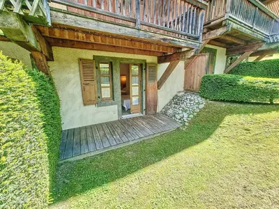 a house with a wooden porch and a balcony at Appartement 2 chambres avec jardin au pied du Mont Blanc - FR-1-560-144 in Combloux