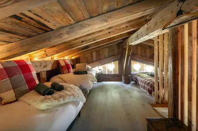 a room with three beds in a cabin at Grand Mazot La Chandelle - OVO Network in Bionnassay