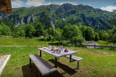 a picnic table in a field with mountains in the background at Grand Mazot La Chandelle - OVO Network in Bionnassay