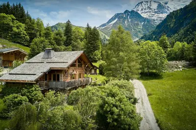 a log cabin in the mountains with a dirt road at Chalet La Chandelle - OVO Network in Bionnassay