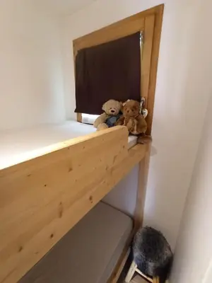 two teddy bears sitting on a shelf in a room at Le Cocon des Carroz, au centre de la station et proximité des pistes, apt 4 pers in Arâches-la-Frasse