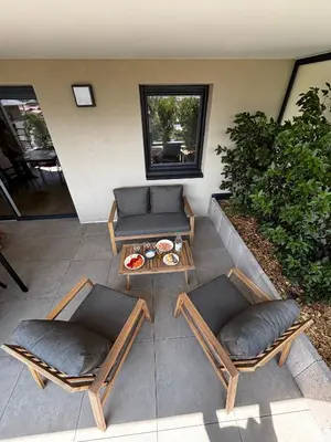 an outdoor patio with two chairs and a table at Vue Mont-Blanc aux pieds des pistes - location cozy pour 2 personnes in Domancy