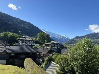 a small village with mountains in the background at Le 202 - Proche telecabine - Vue Montagne in Saint-Gervais-les-Bains