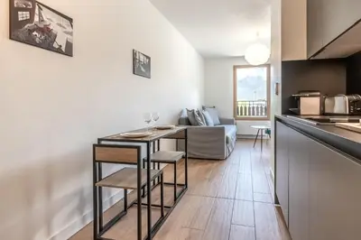 a kitchen and a living room with a table at Le 202 - Proche telecabine - Vue Montagne in Saint-Gervais-les-Bains