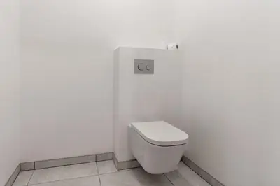 a bathroom with a toilet in a white wall at Le 203 - Proche telecabine - centre ville in Saint-Gervais-les-Bains