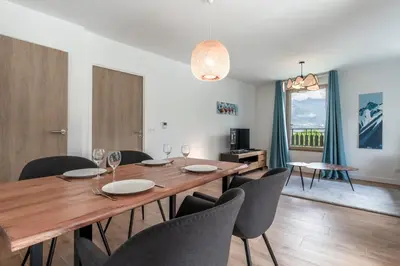 a dining room with a wooden table and chairs at Le 203 - Proche telecabine - centre ville in Saint-Gervais-les-Bains
