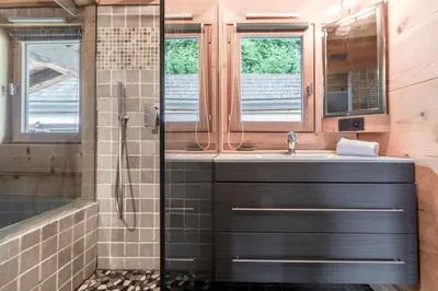a kitchen and living room in a log cabin at Chalet Hygge - Piscine - Calme in Saint-Gervais-les-Bains
