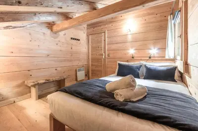 a room with a chair and a window with a view at Chalet Hygge - Piscine - Calme in Saint-Gervais-les-Bains