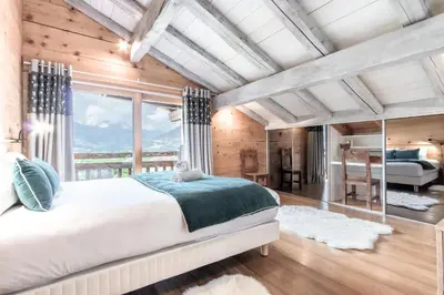 a living room in a log cabin with a window at Chalet Hygge - Piscine - Calme in Saint-Gervais-les-Bains