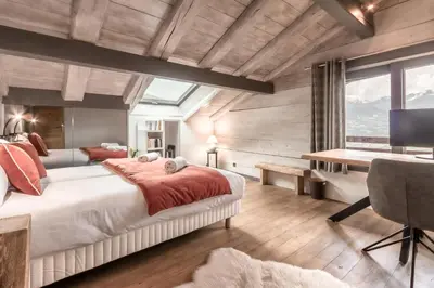 a living room with a blue couch and a table at Chalet Hygge - Piscine - Calme in Saint-Gervais-les-Bains