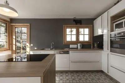 a kitchen with white cabinets and a counter top at Chalet Marie Paradis vue Mont Blanc in Saint-Gervais-les-Bains