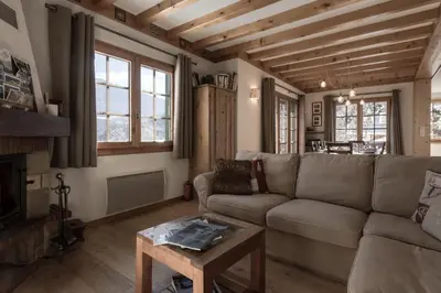 a living room with a couch and a table at Chalet Marie Paradis vue Mont Blanc in Saint-Gervais-les-Bains