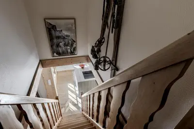 a staircase in a house with a wooden railing at Chalet Marie Paradis vue Mont Blanc in Saint-Gervais-les-Bains